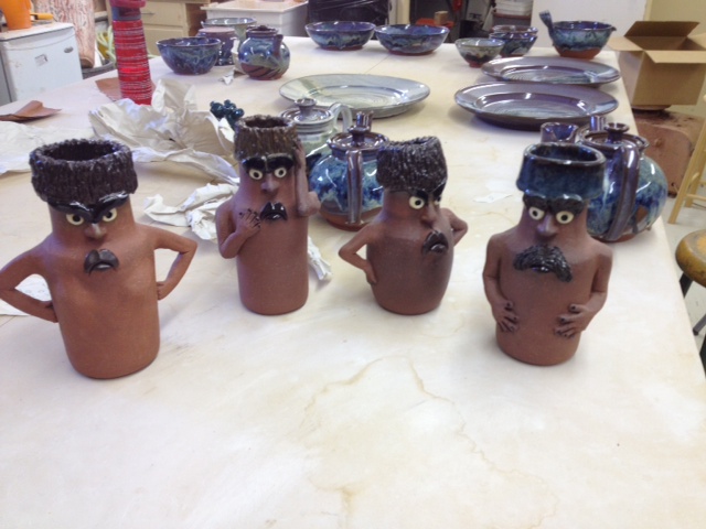 A group of grumpy looking pots. 