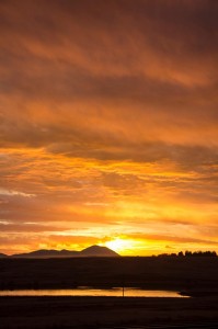 The sun rising over the Sweet Grass Hills