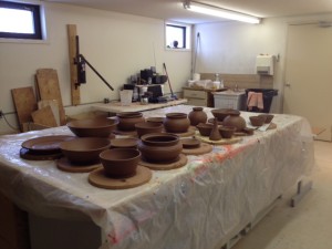 A table of an assortment of wet pots. 